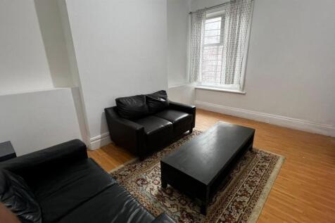 A cozy living room featuring two black leather ...