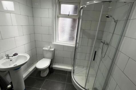 Bright and modern bathroom featuring a curved g...