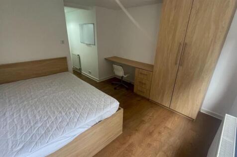 A well-maintained double bedroom featuring a la...