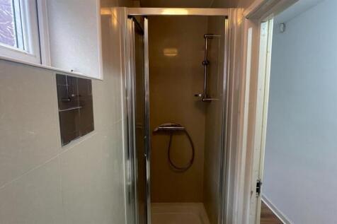 A functional bathroom with a shower area, featu...