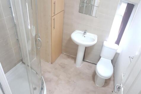 A clean, well-maintained bathroom with a shower...