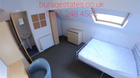 A cozy single bedroom featuring a sloped window...