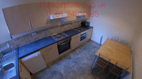 A functional kitchen featuring a long counterto...