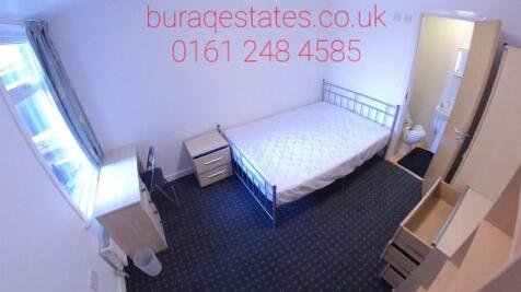 A tidy single bedroom with a metal frame bed, a...