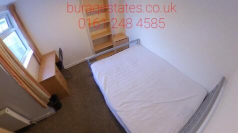 A compact, clean bedroom featuring a single bed...