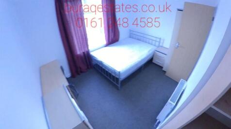 A neat and simple single bedroom with a bed, wa...