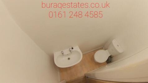 A compact and clean single toilet room with a w...