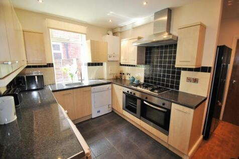 Bright and modern kitchen featuring ample count...