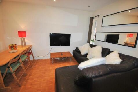 A cozy living room featuring a comfortable blac...