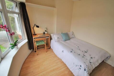 A bright and cozy single bedroom featuring a la...