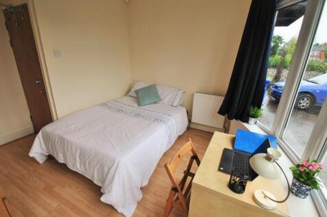 A tidy and well-lit single bedroom featuring a ...