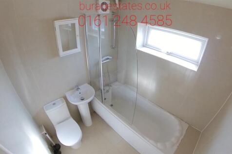 A spacious and well-maintained bathroom with a ...