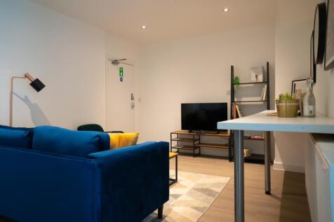 A stylish living room featuring a vibrant blue ...