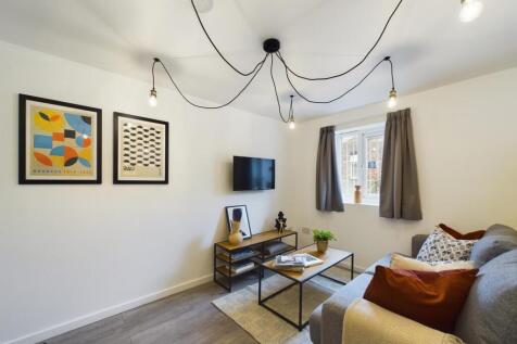 A bright and inviting living room featuring con...