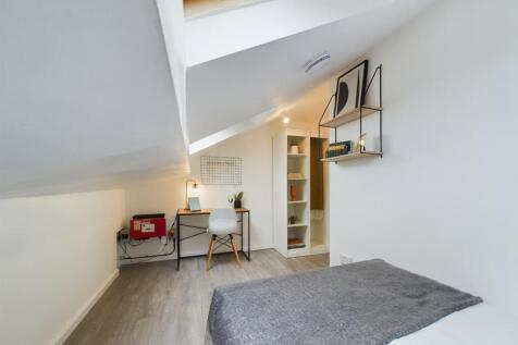 A bright and neatly maintained bedroom with a c...