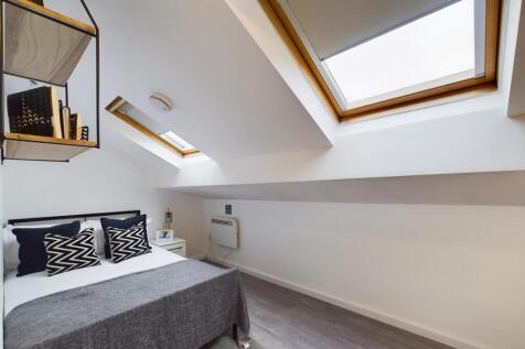 Bright and cozy bedroom with attractive skyligh...