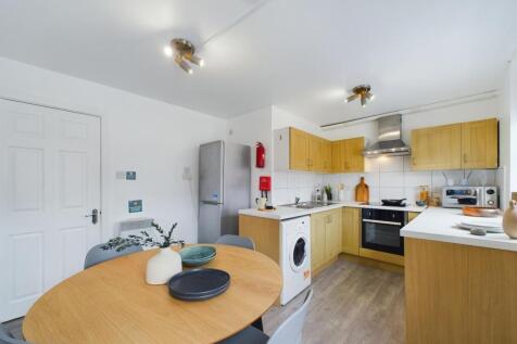 Bright and modern kitchen with ample wooden cab...
