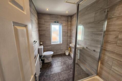 A clean and modern bathroom with a large bath a...