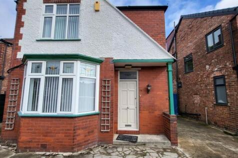 A charming view of a brick-fronted house with a...