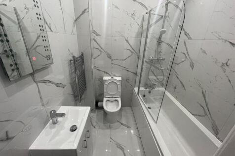 A modern and sleek bathroom featuring a large s...