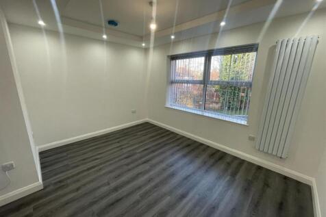 A bright and spacious living room with large wi...