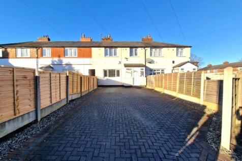 Bright and spacious driveway leading to a well-...