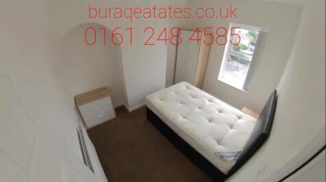 Bright, simply furnished bedroom with a double ...
