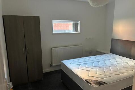 A tidy and modern double bedroom featuring a co...