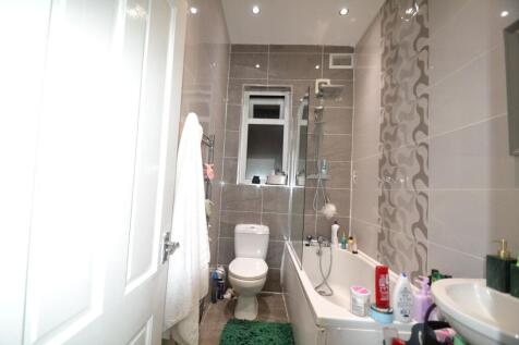 Contemporary tiled bathroom with a combined bat...