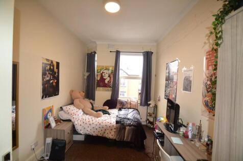 This cozy double bedroom features a comfortable...