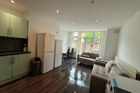 Bright open-plan living area with modern dark w...