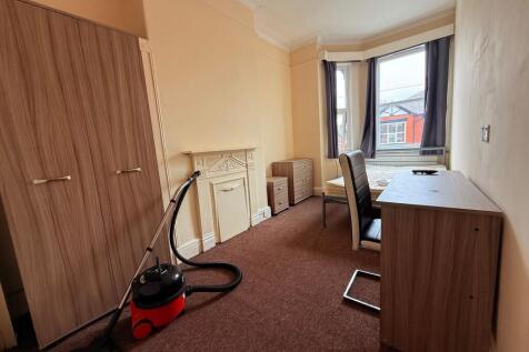 Bright front-facing bedroom with a bay window, ...
