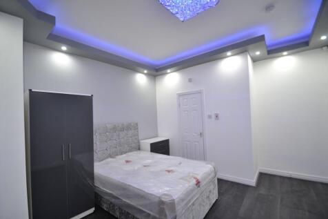 Modern double bedroom with a plush upholstered ...