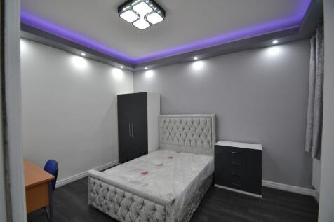 Modern neutral bedroom with a plush upholstered...