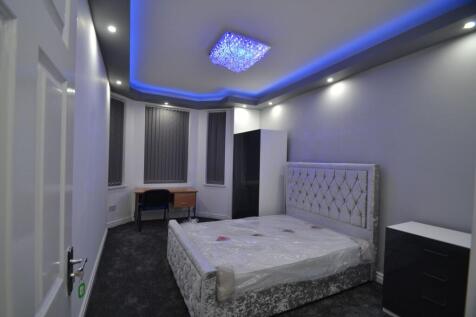 Stylish double bedroom with a plush upholstered...