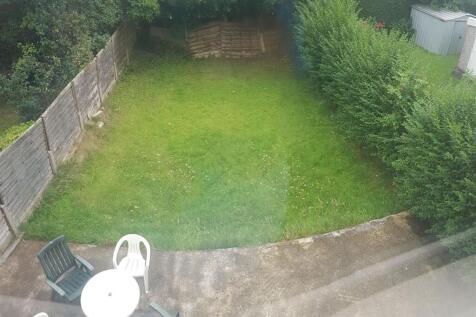 Private rear garden with a paved patio area and...