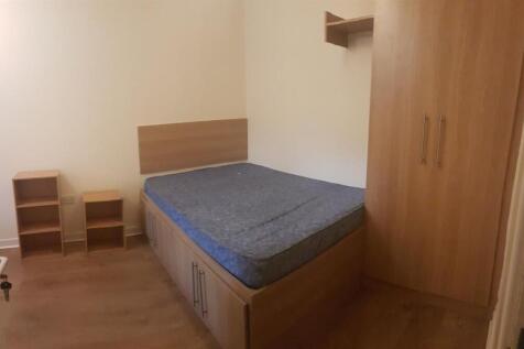 Neat double bedroom with built-in storage under...