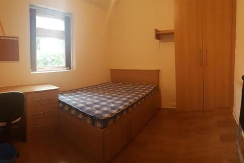 Bright, neat bedroom with a single bed, built-i...