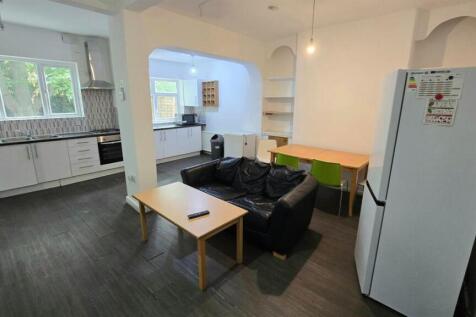 Open-plan living space with a comfortable black...