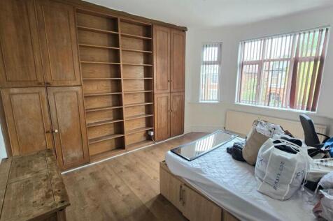 Bright double bedroom with large built-in woode...