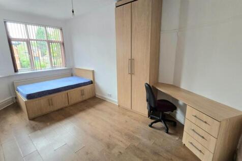 Bright furnished bedroom with a raised bed feat...