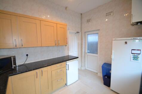 A functional kitchen with wooden cabinets, a bl...