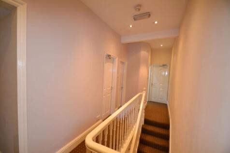 A well-maintained interior hallway with a warm ...