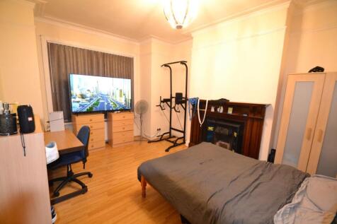 Spacious double bedroom with wooden flooring, l...