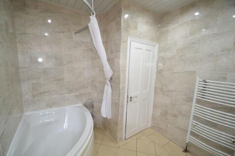 Bright and modern bathroom featuring elegant be...