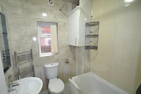 A compact bathroom featuring a toilet, bathtub,...