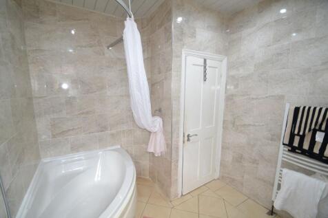 A clean, well-maintained bathroom featuring bei...