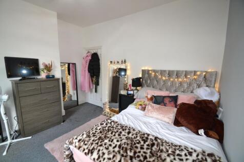 A cozy and well-decorated bedroom with a plush ...