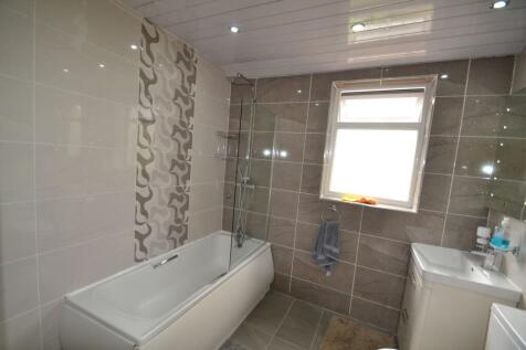 Modern bathroom featuring a spacious bathtub wi...