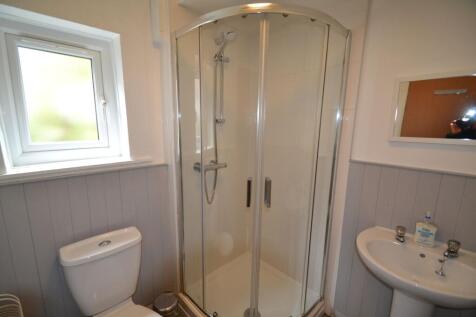 A bright and clean bathroom featuring a spaciou...